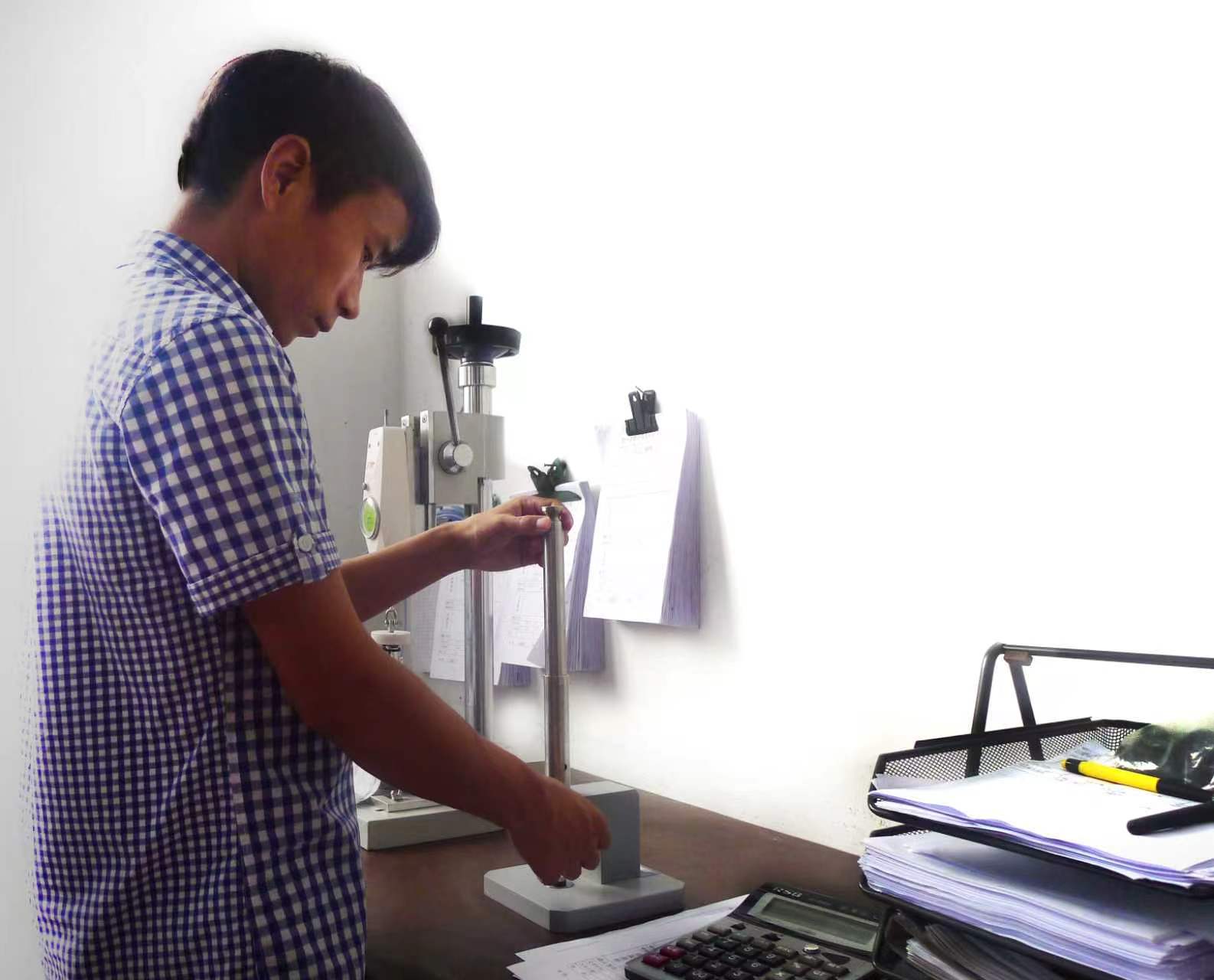 Primotex technician performing a button strength pull test