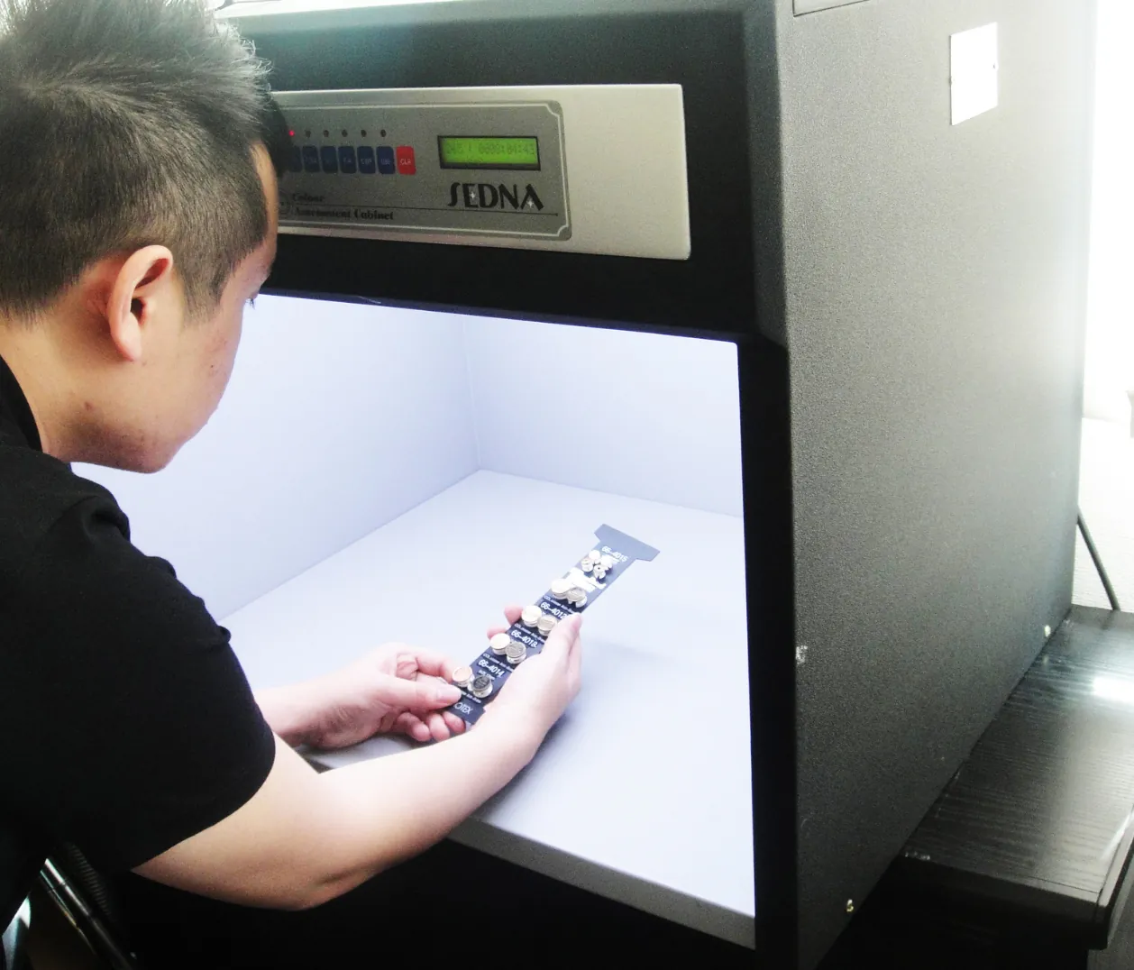 Primotex quality control inspector assessing buttons